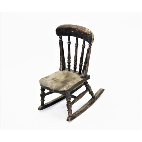 940 - A Victorian painted child's rocking chair, with turned spindles above a shaped seat, 60cm high (some... 