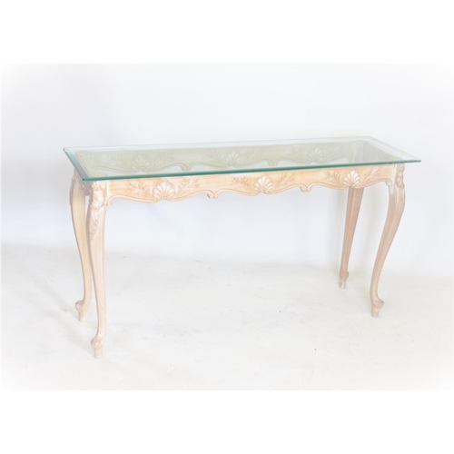 962 - A contemporary limed beech wood glass top console table, having a rectangular bevelled glass top rai... 