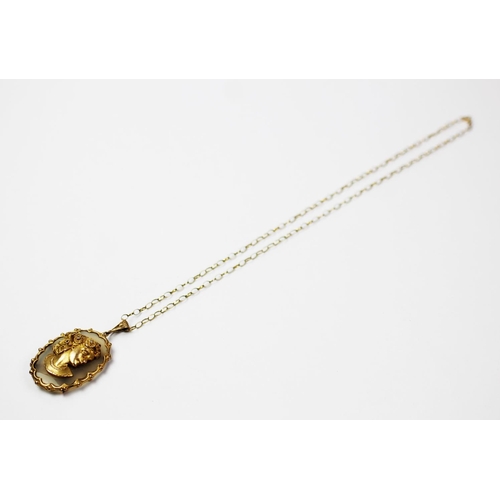 256 - A 9ct gold pendant and chain, London 1974, designed as an oval hardstone panel, set with a gold ladi... 