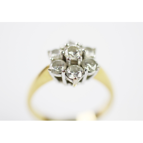 285 - A diamond set cluster ring, designed as a central claw set brilliant cut diamond, in a surround of s... 