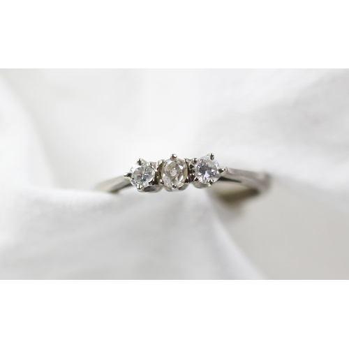 293 - A three stone diamond ring, designed as a central old cut diamond flanked by a brilliant cut diamond... 