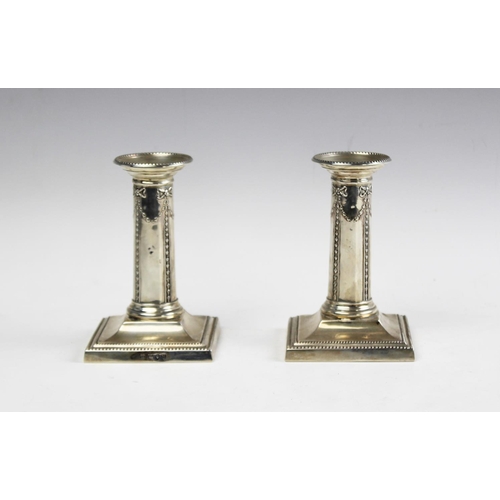 97 - A pair of Victorian silver candlesticks, Thomas Bradbury and Sons, London 1895, each with harebell g... 