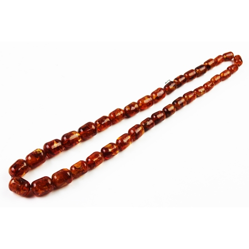 250C - A single strand 'amber' bead necklace, designed as thirty six graduated beads