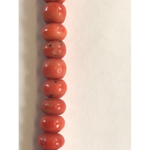 205 - A Victorian coral bead necklace, the seventy uniform beads attached to a coral bead clasp, 47cm long... 