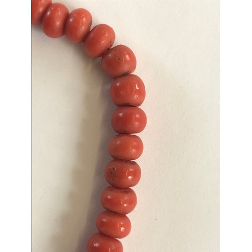 205 - A Victorian coral bead necklace, the seventy uniform beads attached to a coral bead clasp, 47cm long... 