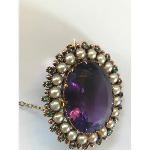 177 - An early 20th century brooch in Suffragette colours, designed as a central claw set amethyst, within... 