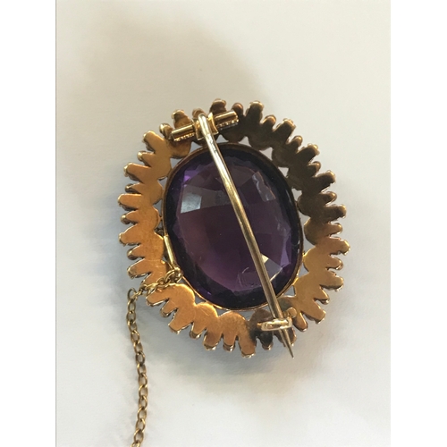 177 - An early 20th century brooch in Suffragette colours, designed as a central claw set amethyst, within... 