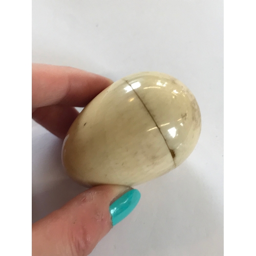 329 - A 19th century ivory etui, the ovoid egg shaped case with screw cover opening to reveal a compartmen... 