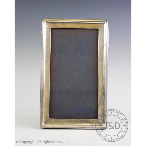 10 - A silver photograph frame, A & J Zimmerman, Birmingham 1917, of rectangular form, with plain polishe... 
