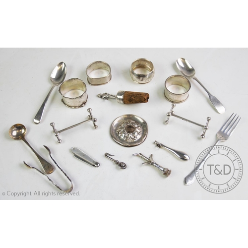 14 - A selection of silver and white metal items, to include, a pair of Victorian silver knife rests, a s... 