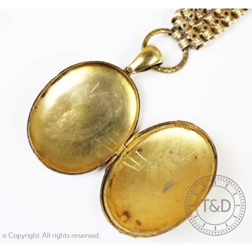 165 - A Victorian gilt metal locket pendant, oval form with engraved monogram and pattern to exterior, att... 