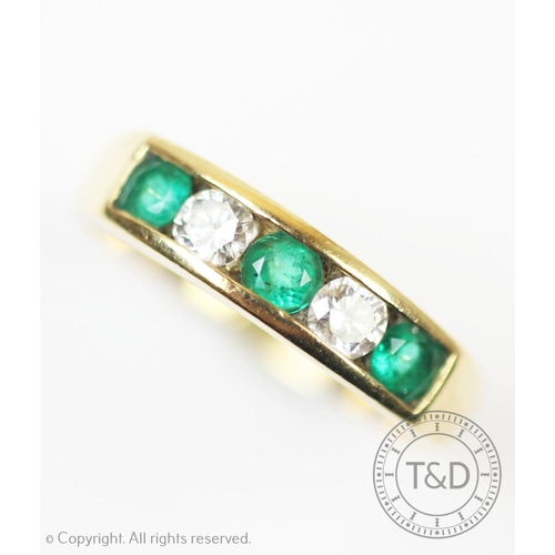 229 - An emerald and diamond five stone ring, the three circular emeralds, interspersed with two brilliant... 