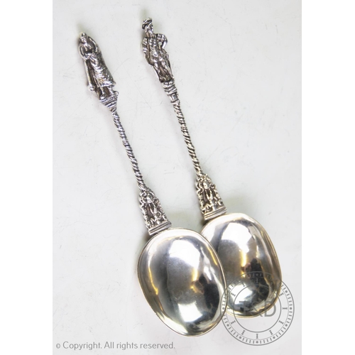 34 - A pair of continental white metal apostle spoons, with oval bowls, chased and rope-twist stems and a... 