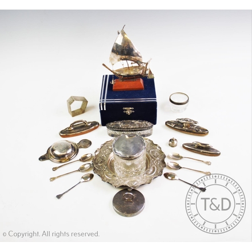 36 - A selection of silver and silver coloured items to include, a white metal ship, on a wooden stand, a... 