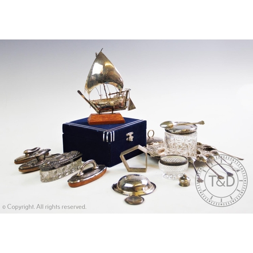 36 - A selection of silver and silver coloured items to include, a white metal ship, on a wooden stand, a... 