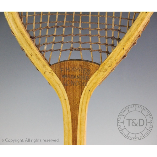 447 - A lawn tennis racket by F.H. Ayres of London circa 1880, with original intact strings the top of the... 