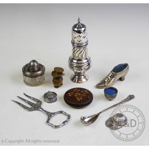 50 - A selection of silver and white metal items, comprising: a white metal tape measure with embossed ca... 