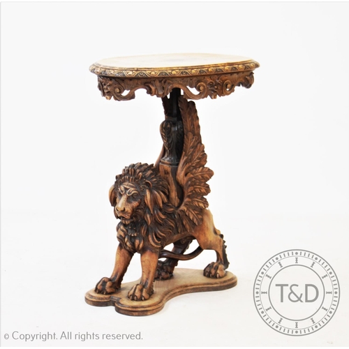 780 - An early 20th century carved walnut griffin figural lamp table, possibly French, the oval top with c... 