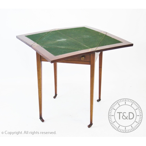 799 - An Edwardian mahogany envelope games table, the square folding top above a single frieze drawer, rai... 