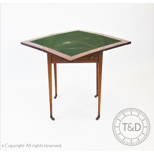 799 - An Edwardian mahogany envelope games table, the square folding top above a single frieze drawer, rai... 