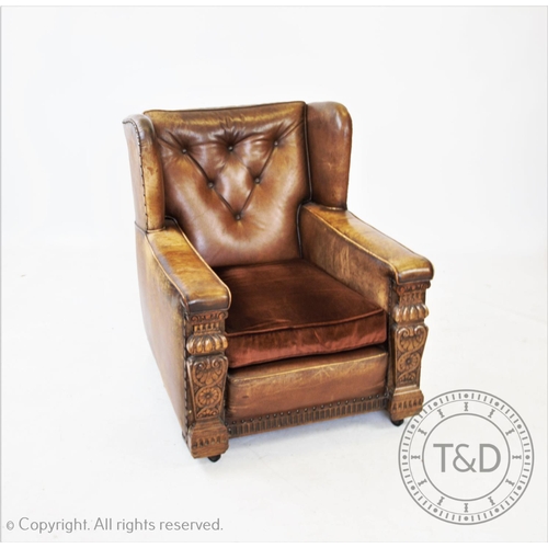 805 - A 1920’s tan leather and oak library chair, with button back, 86cm high