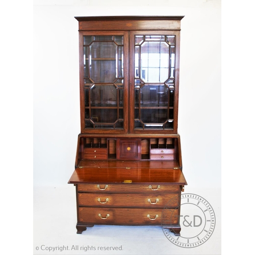 810 - An Edwardian inlaid mahogany Sheraton revival bureau bookcase, having a moulded cornice above an inl... 