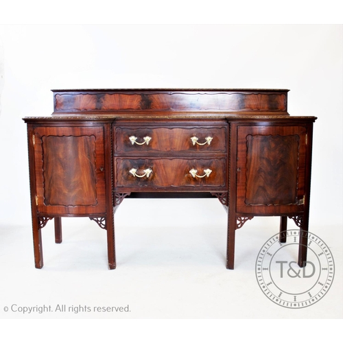 812 - A Chippendale revival mahogany breakfront sideboard, circa 1920, with a dwarf back above two central... 