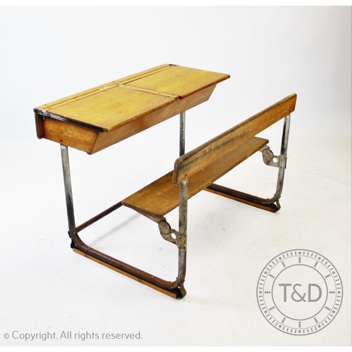 827 - A pair of vintage school desks, the twin combined  beech wood desks and benches mounted upon tubular... 