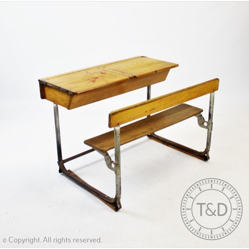 827 - A pair of vintage school desks, the twin combined  beech wood desks and benches mounted upon tubular... 