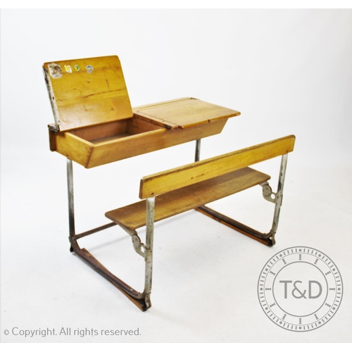 827 - A pair of vintage school desks, the twin combined  beech wood desks and benches mounted upon tubular... 