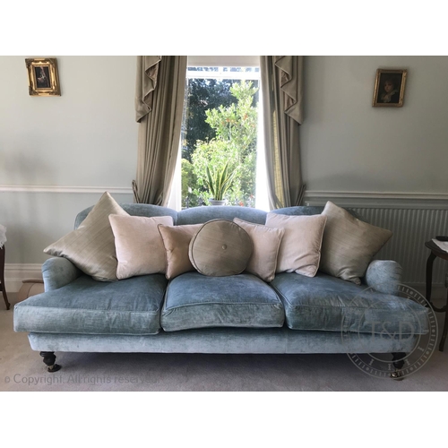 828 - A contemporary three seater sofa, in duck egg blue chenille upholstery, the triple padded back above... 