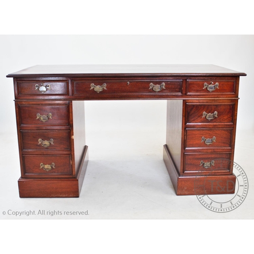 834 - A reproduction twin pedestal mahogany desk, with an arrangement of nine drawers on plinth base, 78cm... 