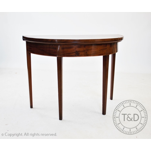 835 - An early 19th century mahogany demi lune folding tea table, on tapering square legs, 73cm H x 101cm ... 