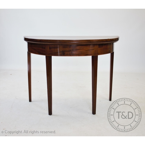 835 - An early 19th century mahogany demi lune folding tea table, on tapering square legs, 73cm H x 101cm ... 