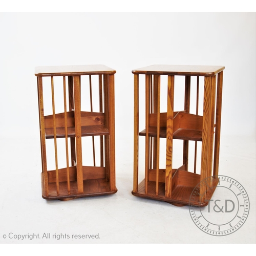 836 - A pair of modern honey oak revolving bookcases, 75cm H x 45cm W x 45cm D (2)