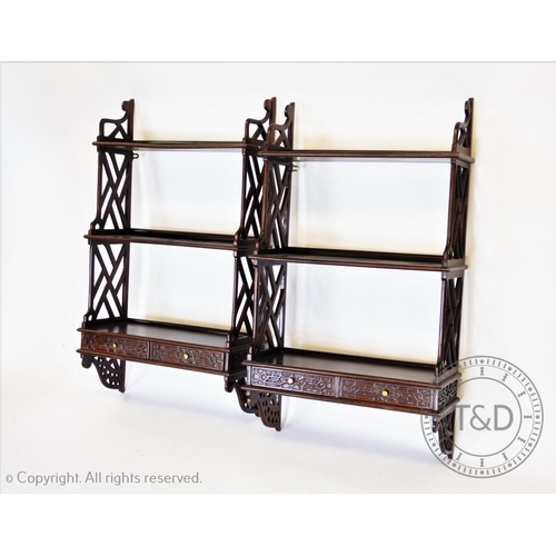 838 - A pair of Chippendale style mahogany wall shelves, 20th century, each wall shelf with three graduate... 