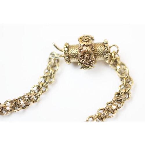 192 - A 19th century muff chain, the fancy link chain measuring 123cm, barrel clasp with applied floral de... 