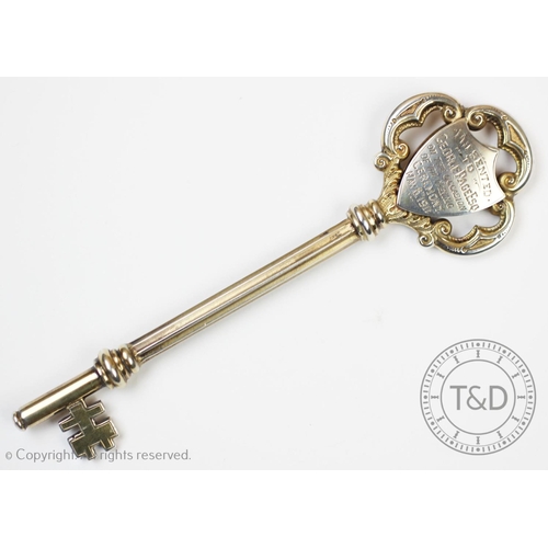 33 - A silver presentation key, for the Burslem Industrial Co-operative Society Milton Branch, engraved i... 