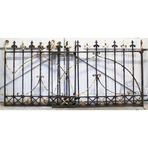 842 - A pair of wrought iron gates, late 19th/early 20th century, with fleur de lis terminals upon iron ra... 