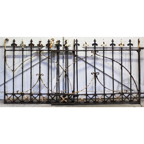 842 - A pair of wrought iron gates, late 19th/early 20th century, with fleur de lis terminals upon iron ra... 