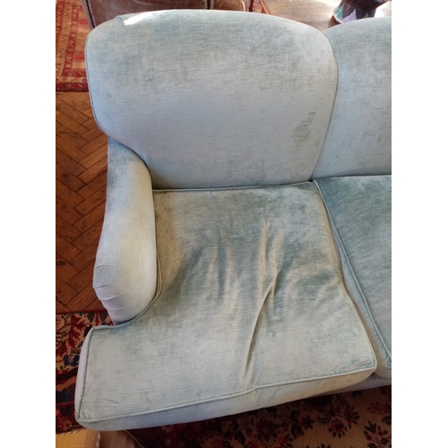 828 - A contemporary three seater sofa, in duck egg blue chenille upholstery, the triple padded back above... 