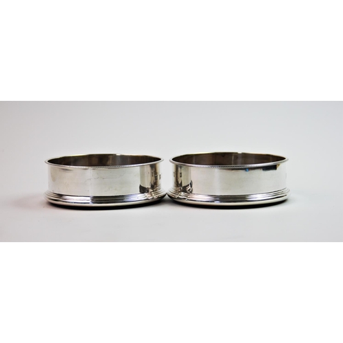 2 - A pair of silver mounted bottle coasters, P H Vogel & Co, Birmingham 1998, of circular plain polishe... 