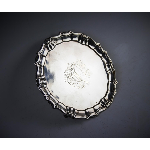 46 - A George II silver waiter, London 1744, with piecrust and shell rim, of plain polished form with cen... 
