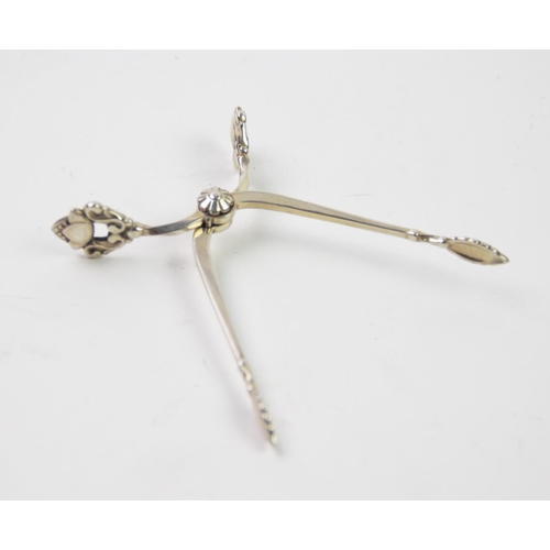 72 - A pair of Danish silver acorn pattern sugar tongs, Georg Jensen, import marks for London 1931, with ... 