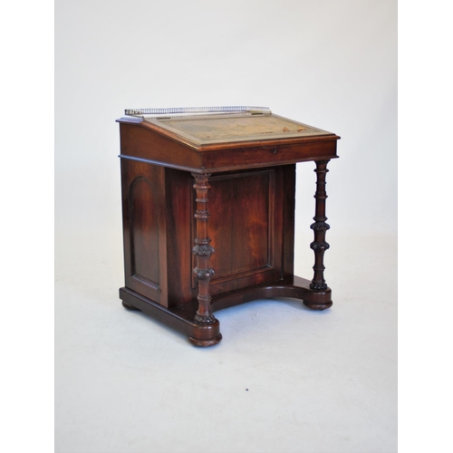 812 - A Victorian walnut davenport, the satinwood interior with six small drawers, upon two ring turned an... 