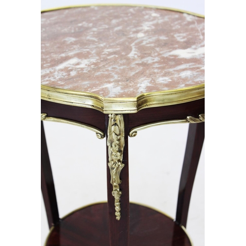 823 - An early 20th century French rouge marble top occasional table, the circular marble top raised upon ... 