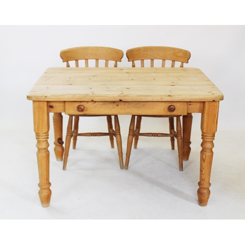 824 - A Victorian style pine slab top kitchen table, with a single frieze drawer, raised upon turned legs,... 