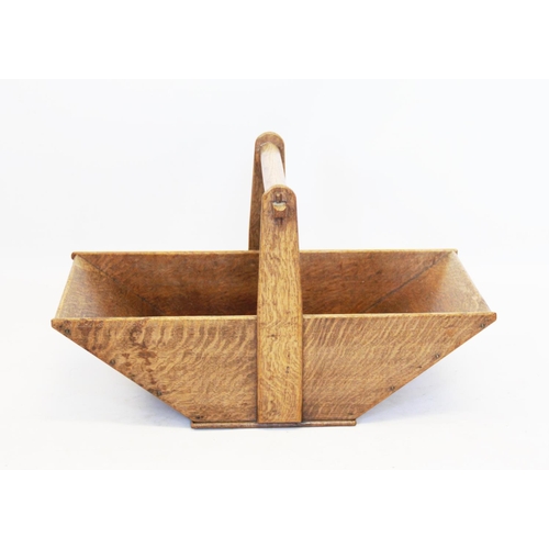 826 - A late 19th century oak trug, of tapering form with a turned fixed overhead handle, 60cm long