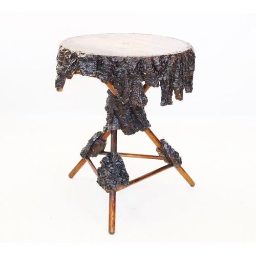 835 - A rustic hardwood bark table, early 20th century, the circular top applied with a shaped bark frieze... 