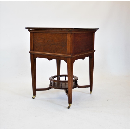 841 - An early 20th century metamorphic oak drinks table/ cabinet by Finnigans Ltd, Manchester, with a ris... 